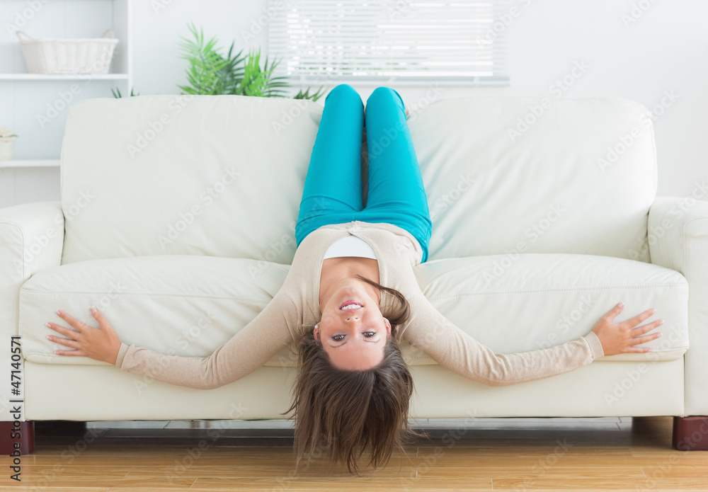 Funny woman lying upside down on sofa Funny woman lying upside down on sofa