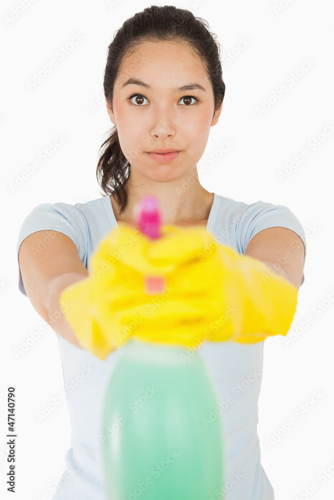 Brunette woman pointing spray bottle Brunette woman pointing spray bottle