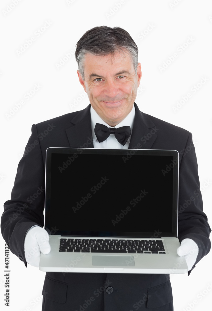 Smiling waiter showing us something on a laptop Smiling waiter showing us something on a laptop