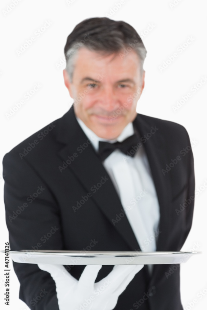 Waiter holding a silver tray out Waiter holding a silver tray out