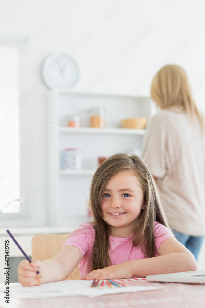 Girl sitting at the kitchen smiling Girl sitting at the kitchen smiling