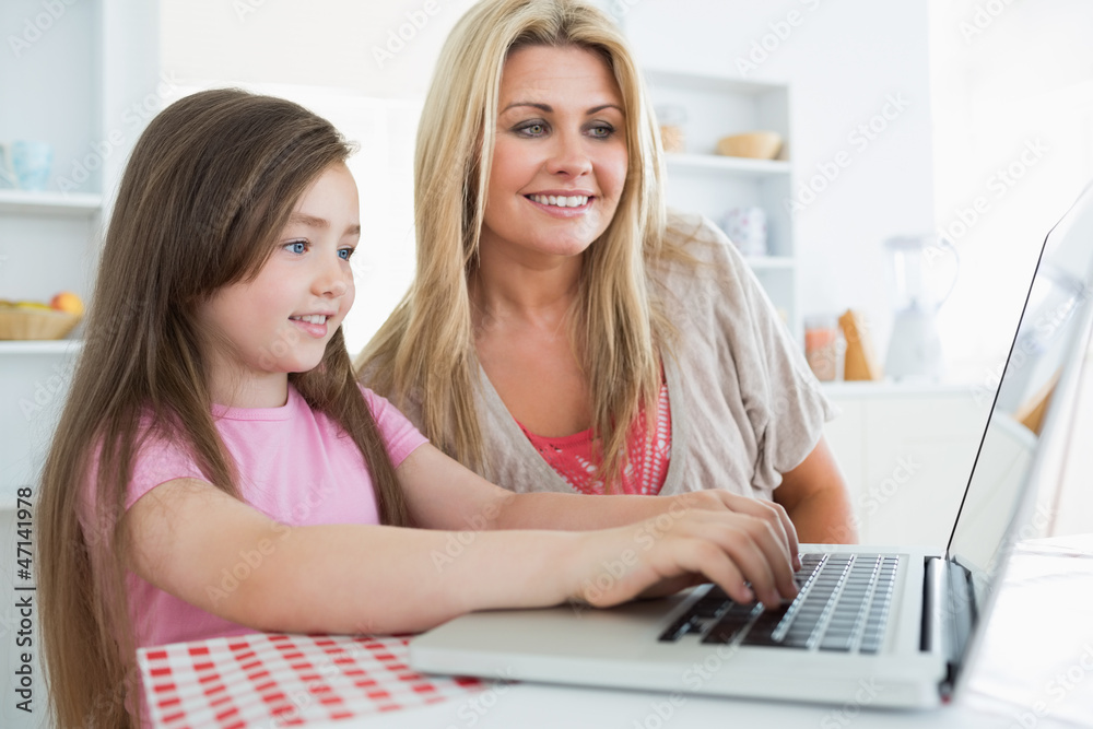 Mother and daughter sitting at the kitchen Mother and daughter sitting at the kitchen
