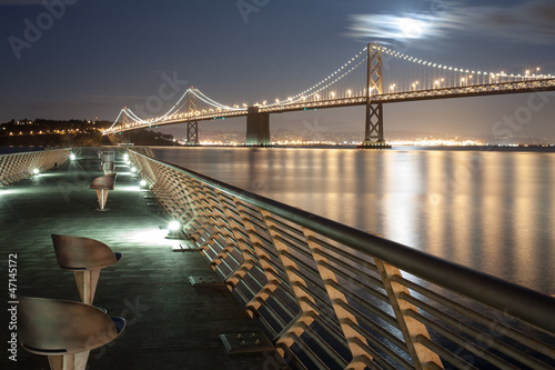 Photography Bay Bridge at Full Moon Night from pier in San Francisco