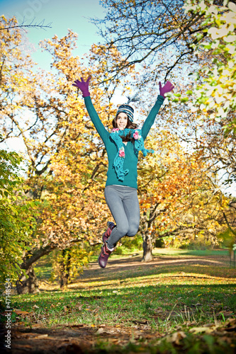 Beautiful girl jumping  in a park