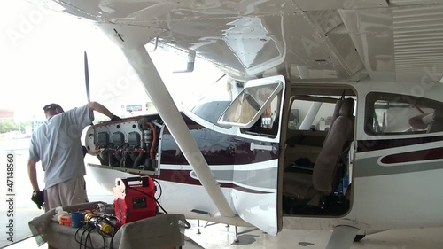 Airplane Mechanic Working on Engine