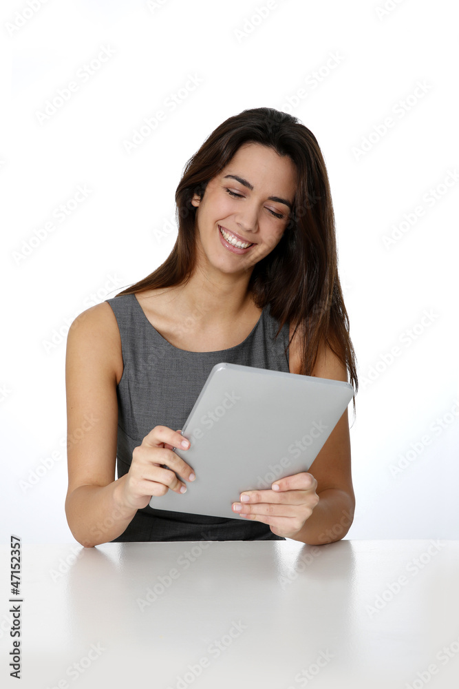 Smiling brunette girl websurfing with digital tablet Smiling brunette girl websurfing with digital tablet