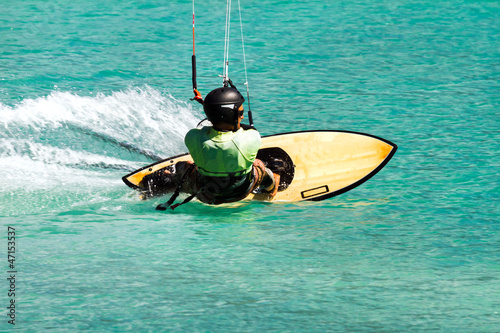 kite surfer in emerald water
