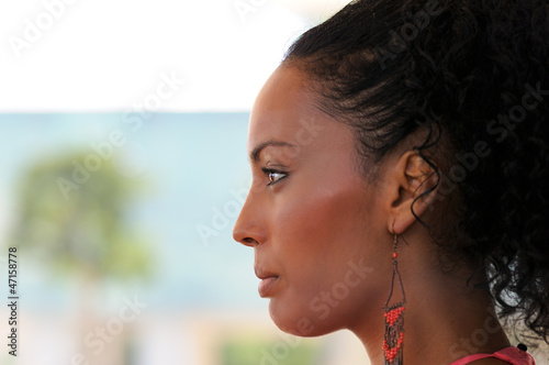 Black woman with earrings. Afro hairstyle