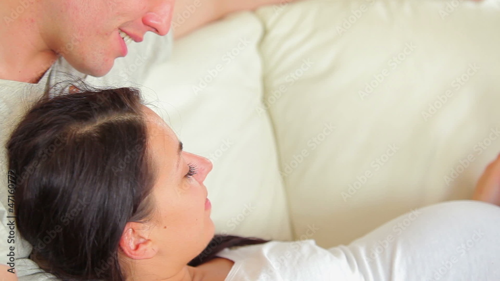 Couple relaxing and looking at ultrasound scan of baby Couple relaxing and looking at ultrasound scan of baby