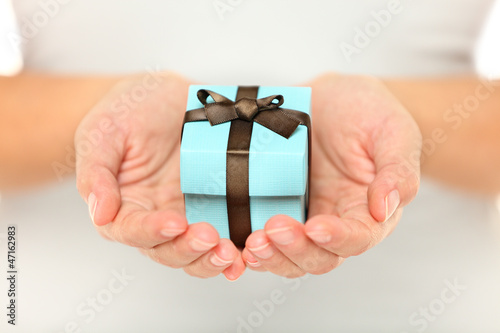 Female hands holding a gift