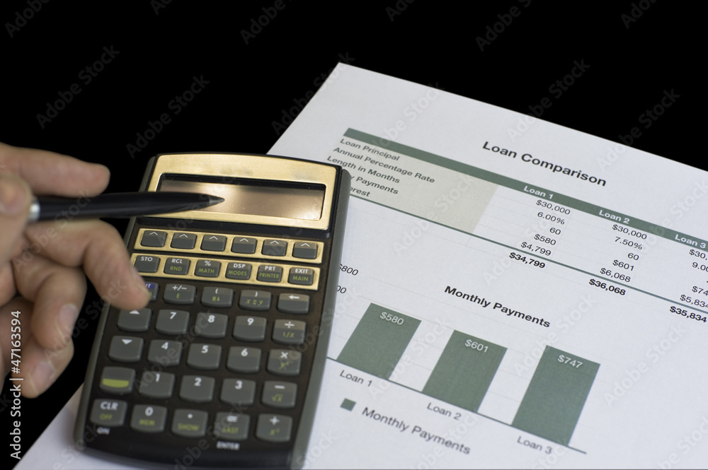 Loan comparison, data sheets, calculator and pen Loan comparison, data sheets, calculator and pen