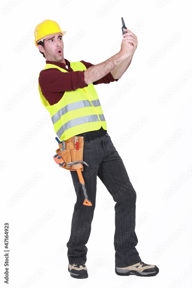 Construction worker shocked at his walky talky Construction worker shocked at his walky talky