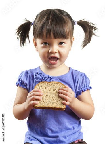 Young child eating sandwich