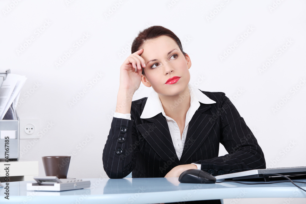 Business woman in sitting at the desk and thinking Business woman in sitting at the desk and thinking