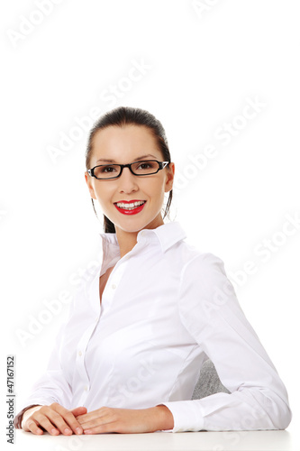 Pretty young woman in sitting at the desk