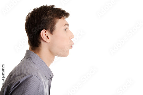 Young man blowing on something