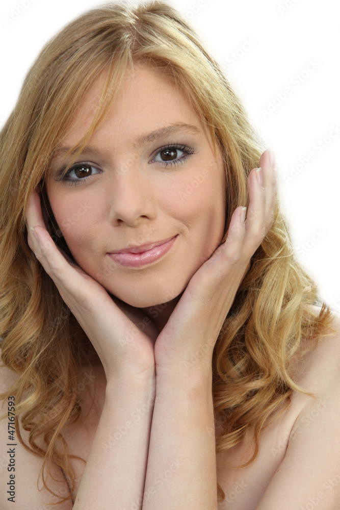 blonde with curly hair smiling with face resting on hands blonde with curly hair smiling with face resting on hands