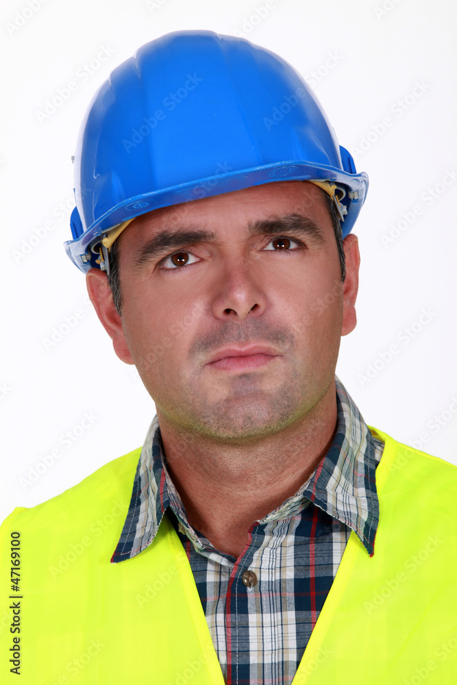 Puzzled construction worker
