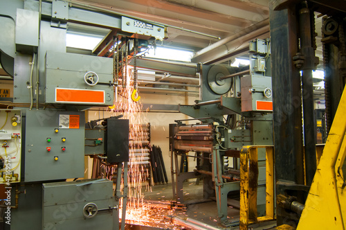 Demolition of old printing press with shower of sparks photo