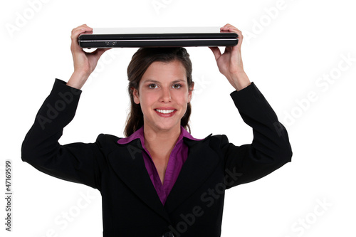 Woman holding a laptop on her head