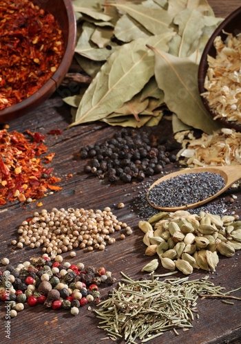 Fototapeta Naklejka Na Ścianę i Meble -  Different spices over a dark wood. Selective focus