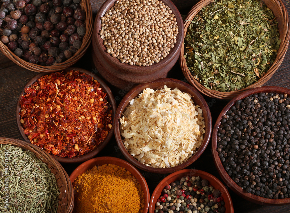 Different bowls of spices over a wooden background Different bowls of spices over a wooden background