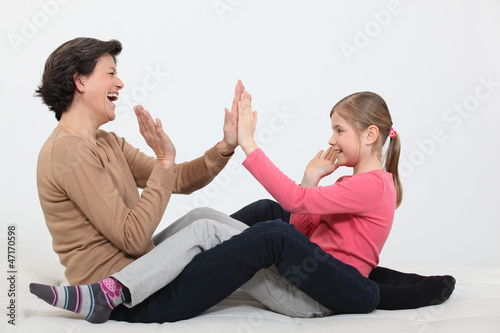 Woman and girl clapping hands