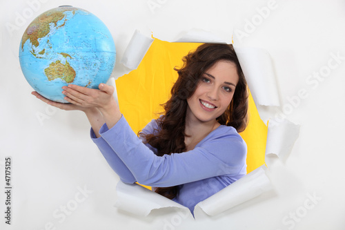 a woman showing a globe photo