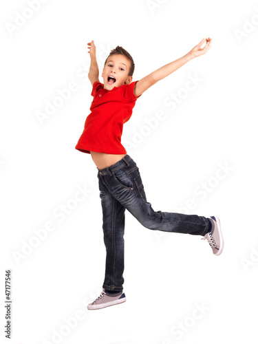 Happy boy jumping with raised hands up