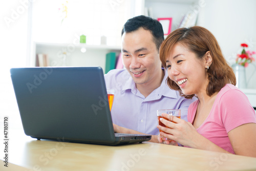 Asian couple using notebook © WONG SZE FEI