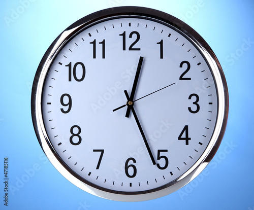 round office clock on blue background