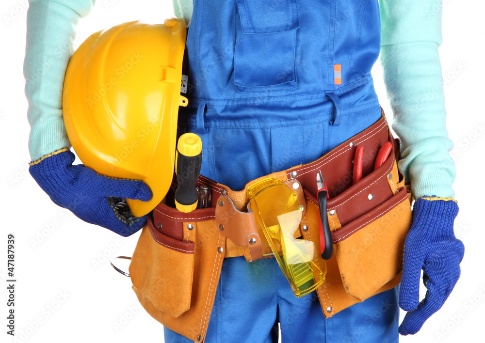 Male builder in blue overalls with yellow helmet isolated Male builder in blue overalls with yellow helmet isolated
