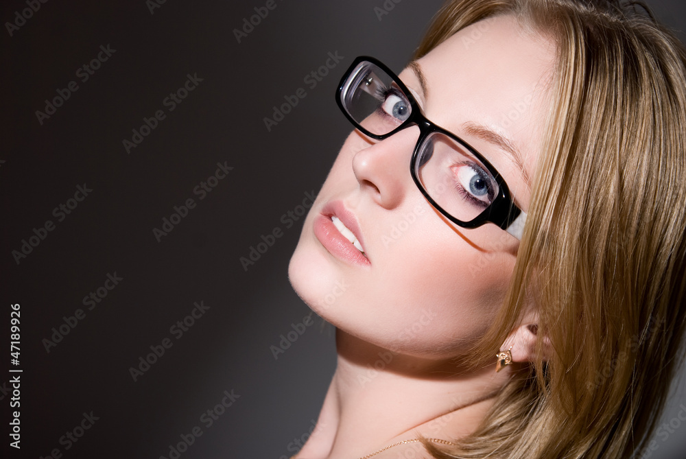 Close-up portrait of beautiful girl in glasses