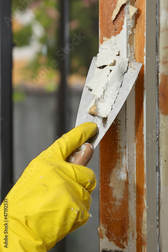 Old window restoration, remove paint with scraper photo