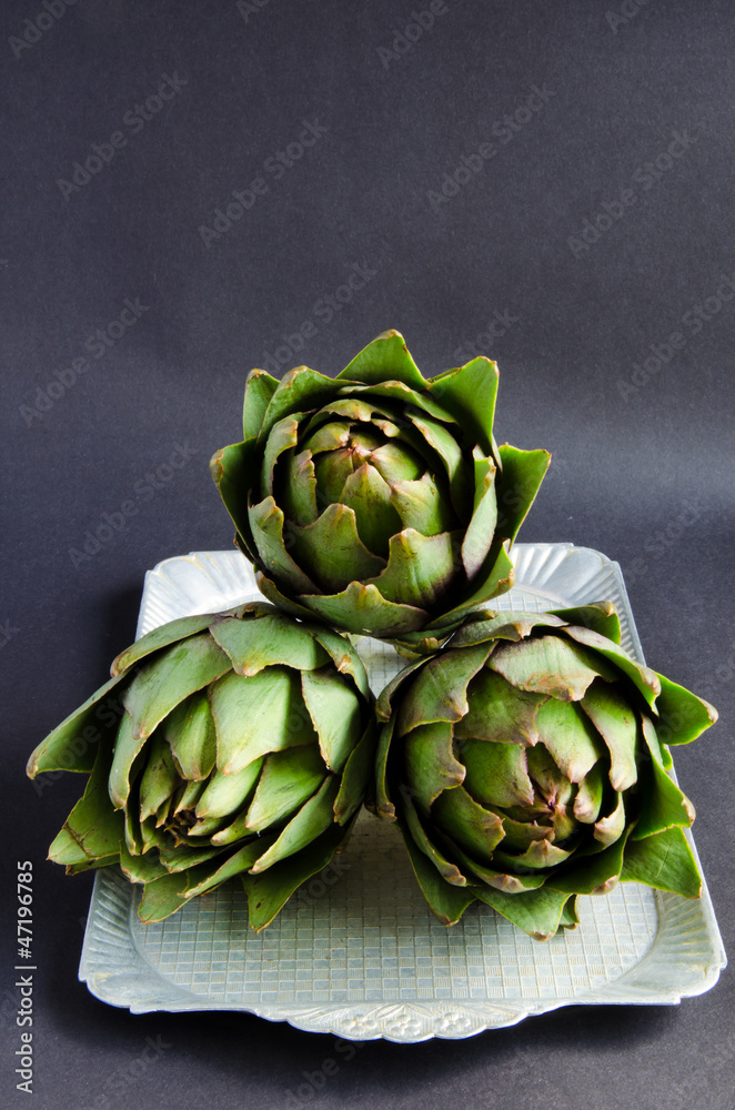 Fototapeta premium Artichokes On The Grey Background