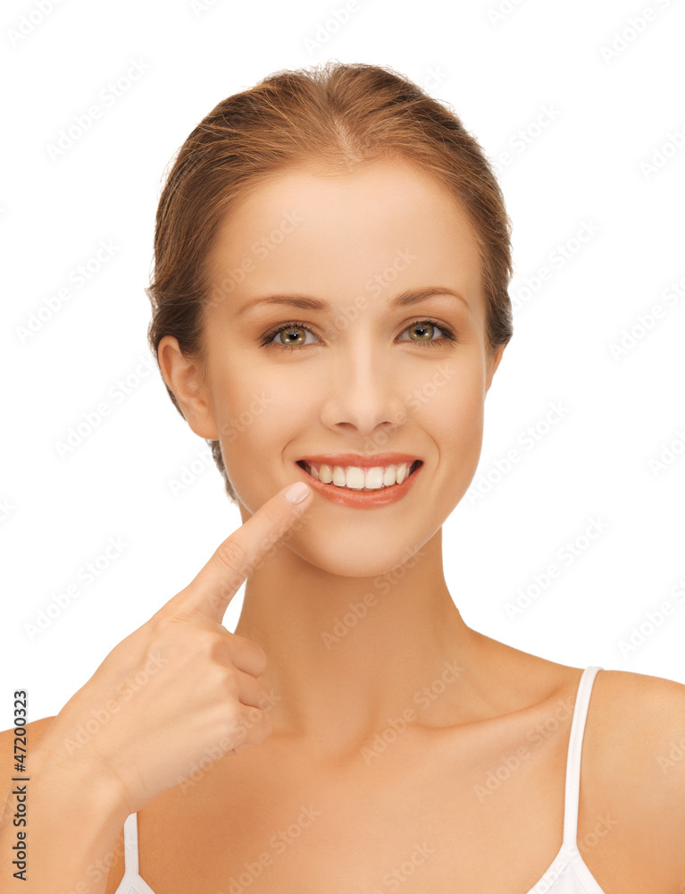 beautiful woman pointing to teeth