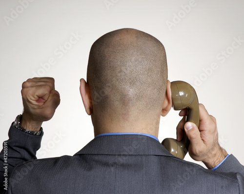 Exitoso ejecutivo hablando por teléfono,cabeza de hombre calvo. photo