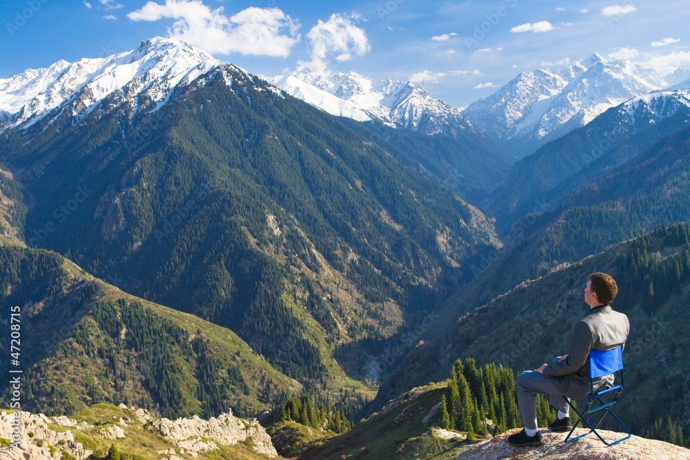 businessman at the top of the mountain is thinking about fut