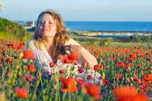Girl with flowers near the sea