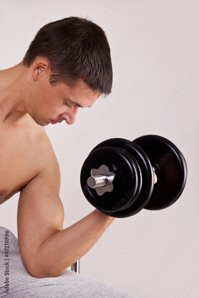 handsome man uses dumbbells handsome man uses dumbbells