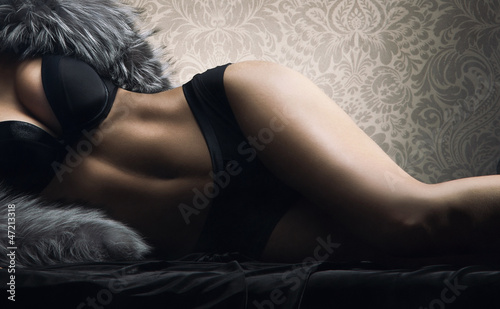 Vászonkép Sexy body of a young woman laying in erotic lingerie