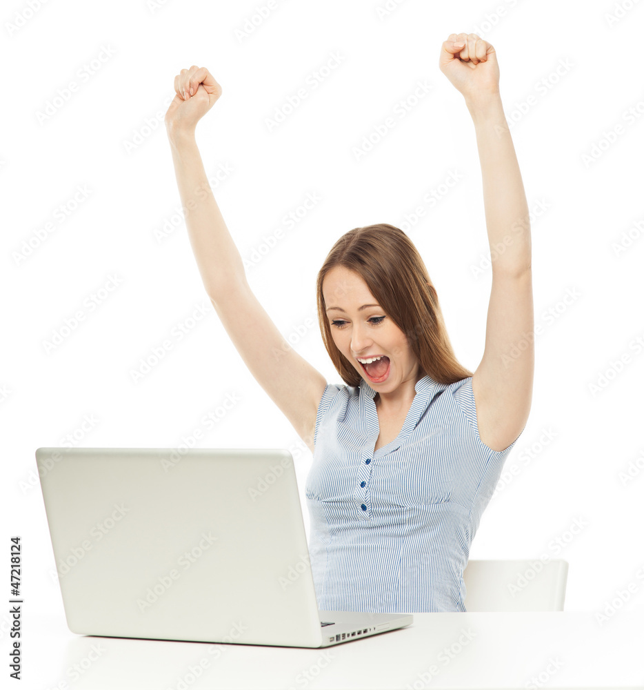 Woman raising her arms in front of laptop Woman raising her arms in front of laptop
