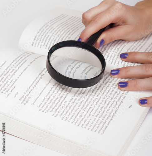 magnifying glass over book