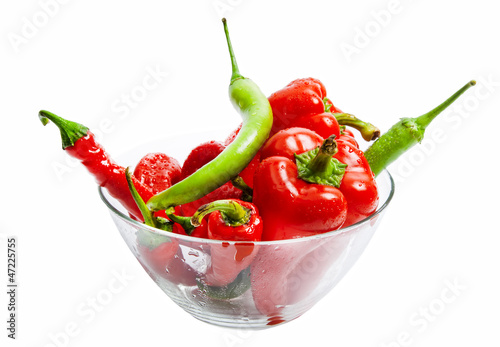 Red and green chili and bulgarian pepper in glass dish isolated