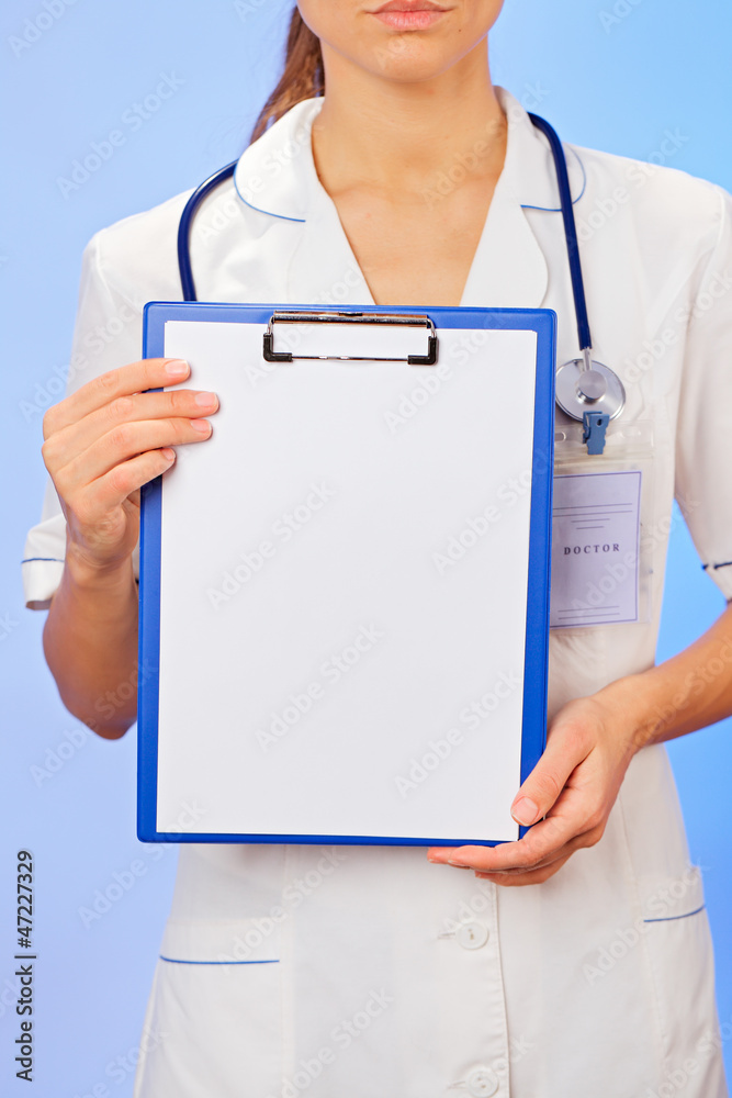 Doctor with copyspaced clipboard waist-high portrait on blue Doctor with copyspaced clipboard waist-high portrait on blue