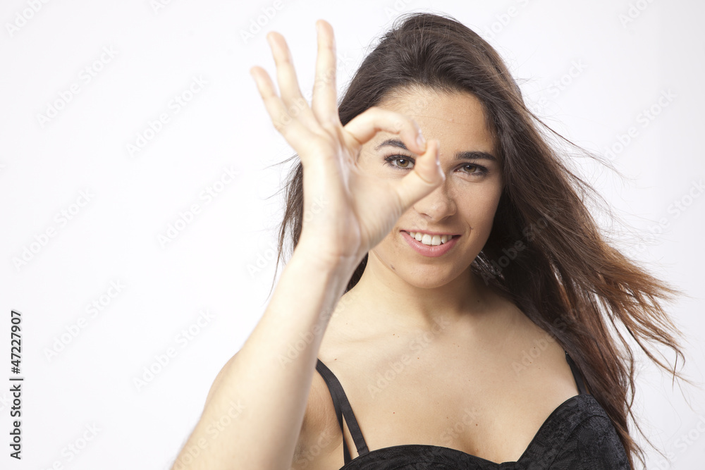real beautiful young girl making an OK with the hand real beautiful young girl making an OK with the hand