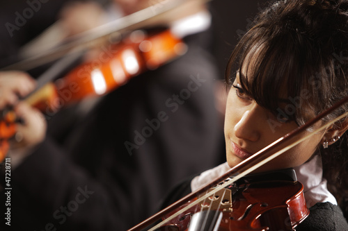 Violinist woman playing a concert of classical music