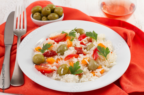 salad with rice and vegetables on the white plate