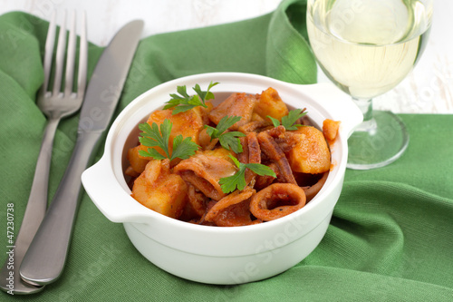squid with potato and tomato sauce in the bowl