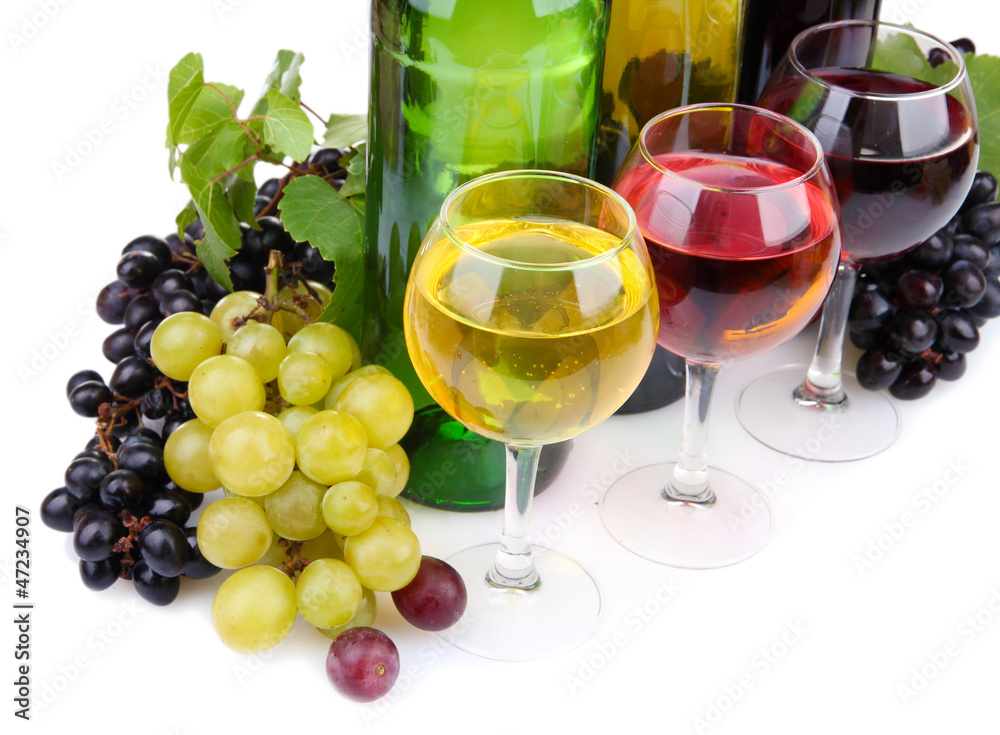 bottles and glasses of wine and assortment of grapes, isolated